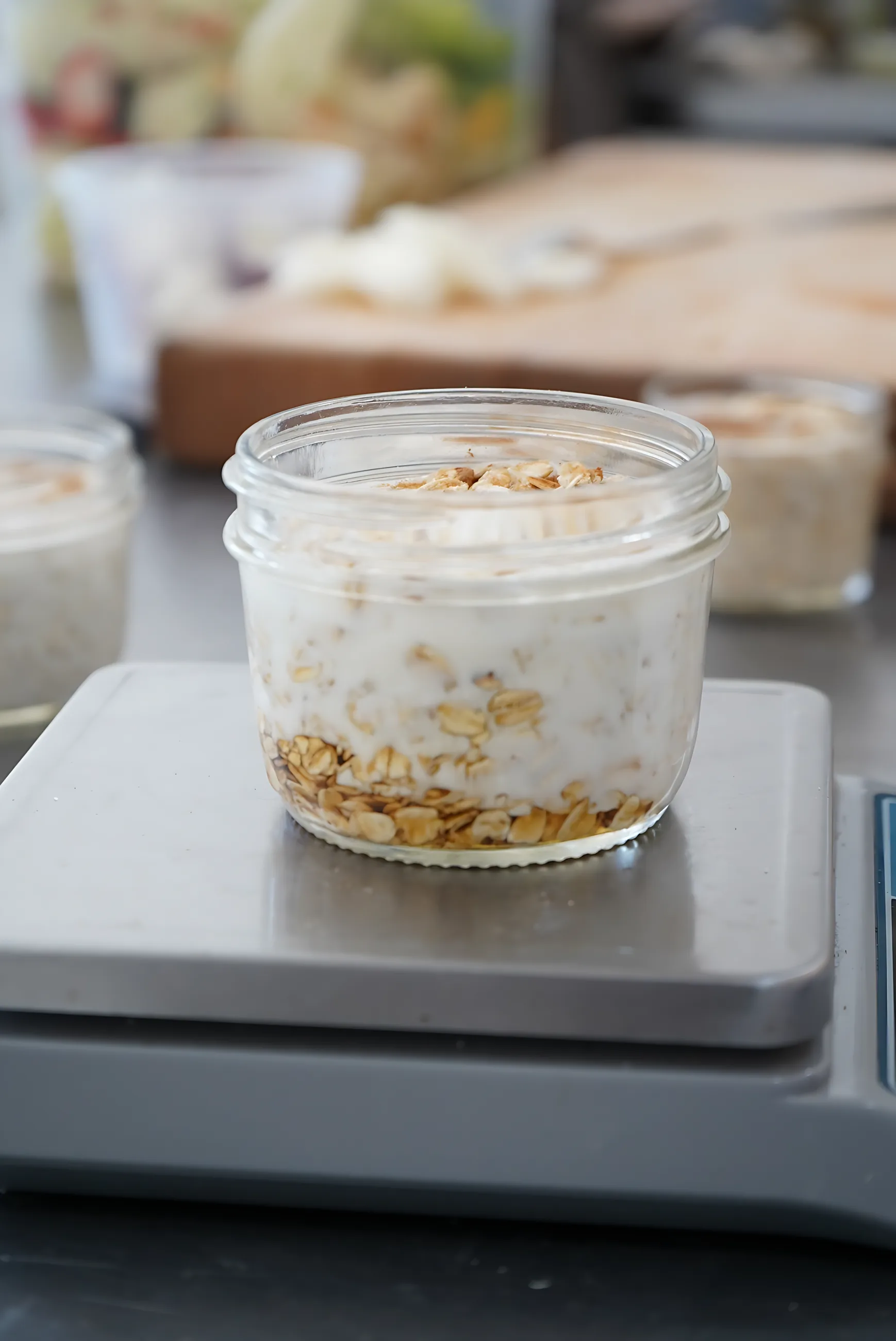 Overnight oats in a glass jar on a kitchen scale