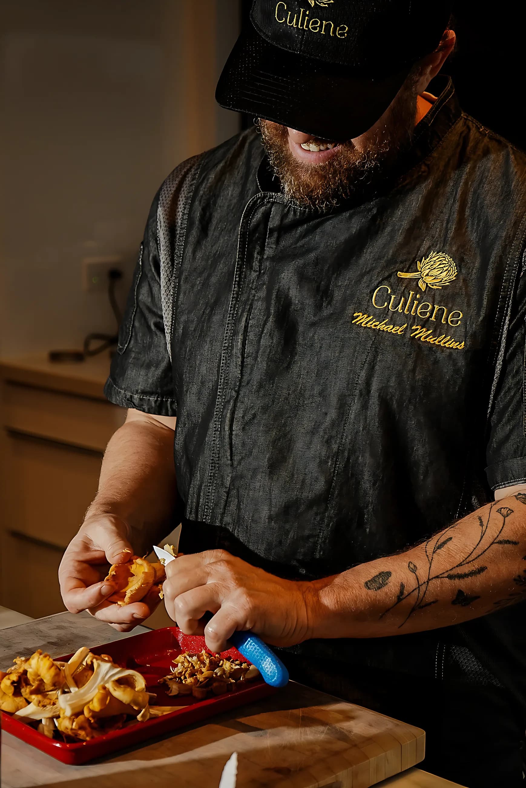 A Culiene chef cleaning chanterelle mushrooms at the counter