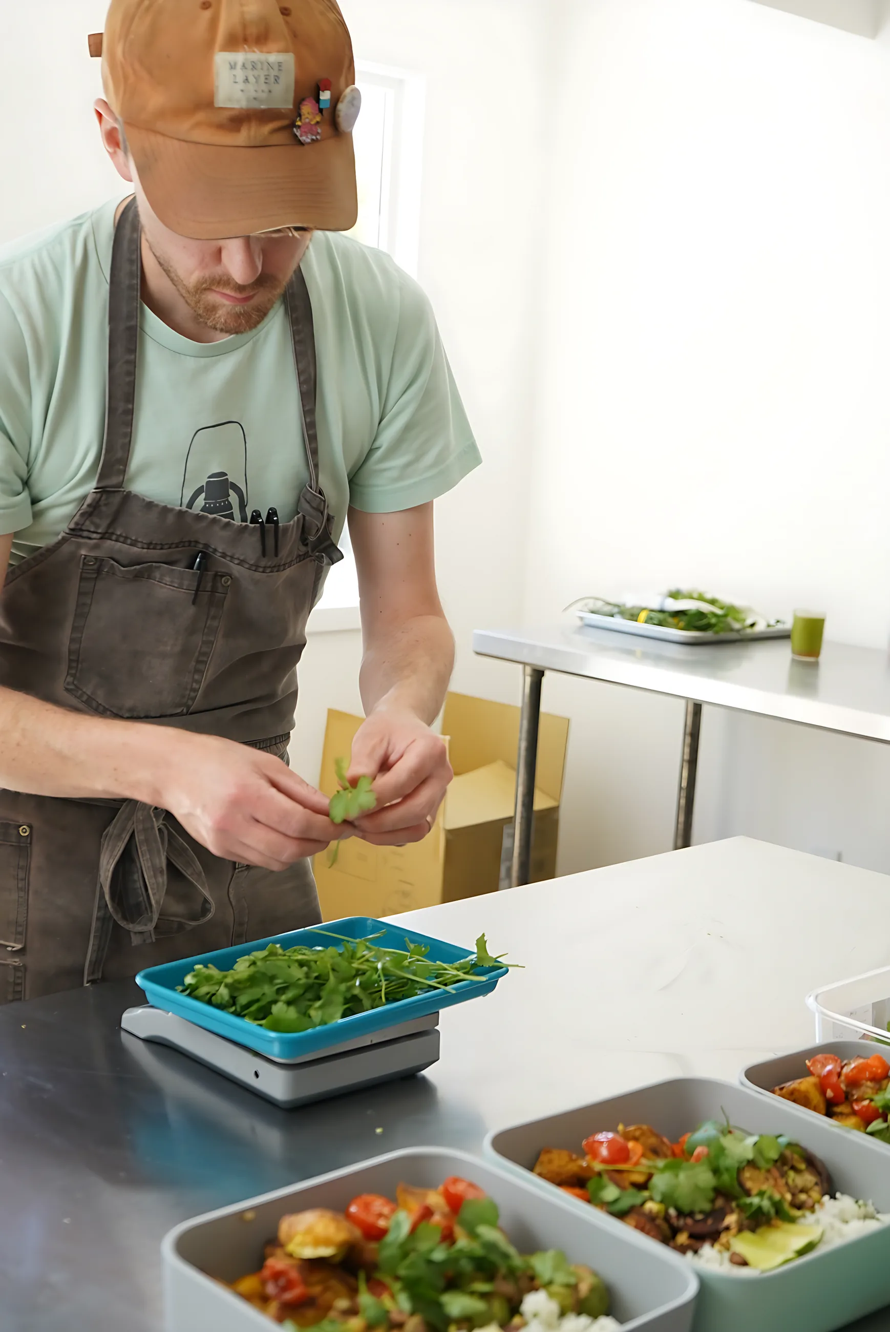 A Culiene chef packing the day's meals into containers